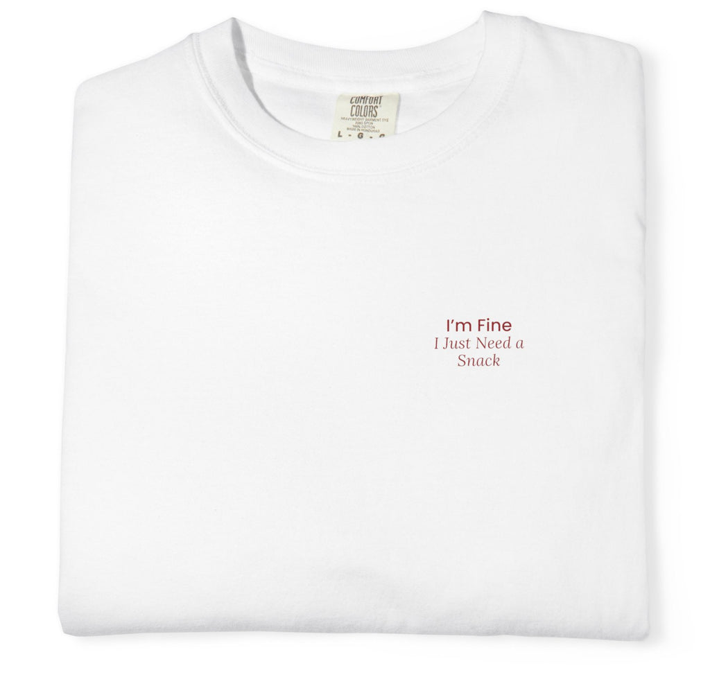 White t-shirt with text 'I'm Fine, I Just Need a Snack' on a white background