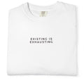White t-shirt with 'EXISTING IS EXHAUSTING' text on a white background