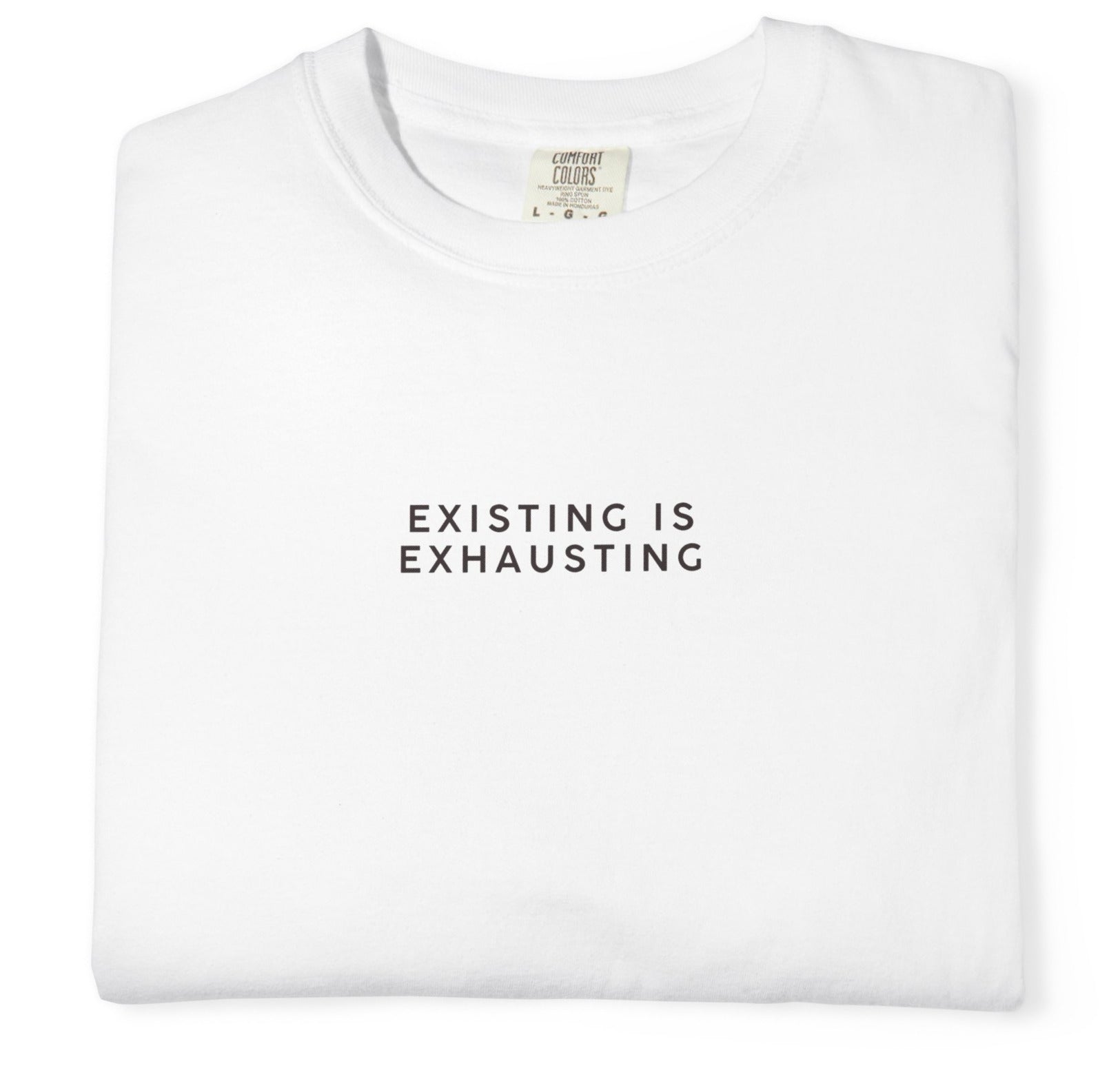 White t-shirt with 'EXISTING IS EXHAUSTING' text on a white background